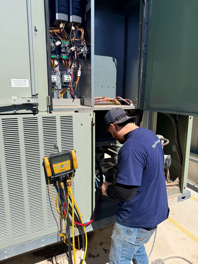 Cool Bear technician running diagnostics on a commercial heating unit